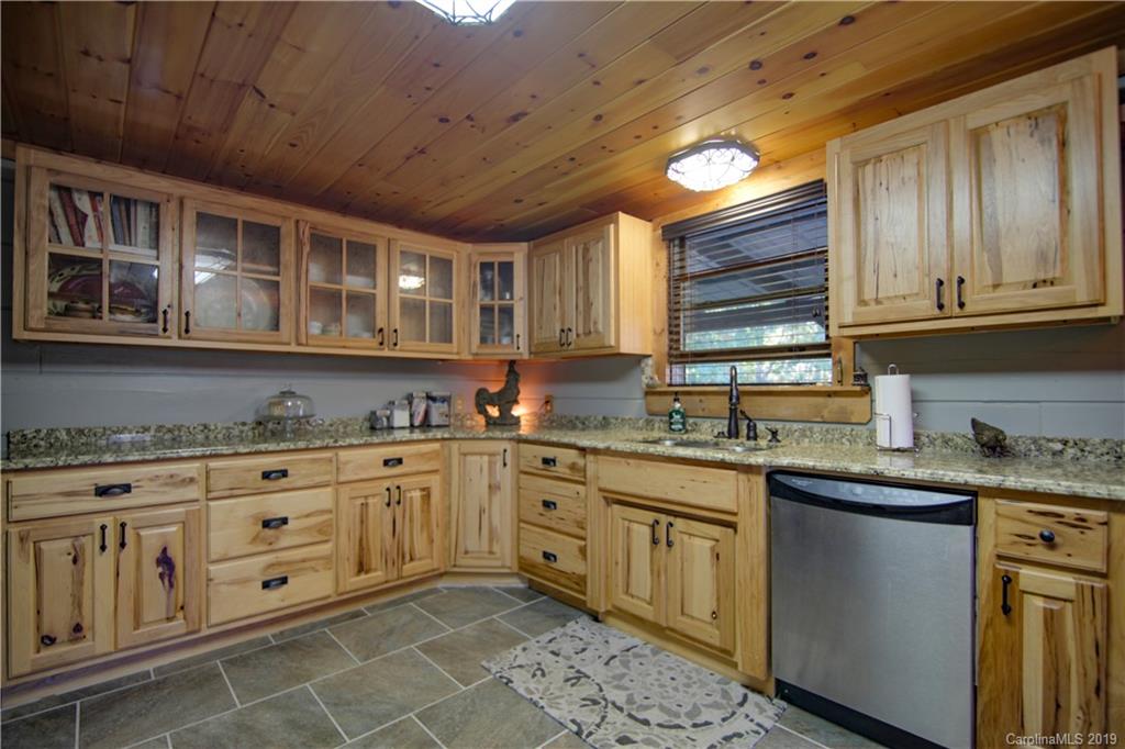 75 Stanley Dr Mill Spring Mill Spring, NC 28756 - Photo 11 of 48 a kitchen with stainless steel appliances granite countertop a sink and cabinets