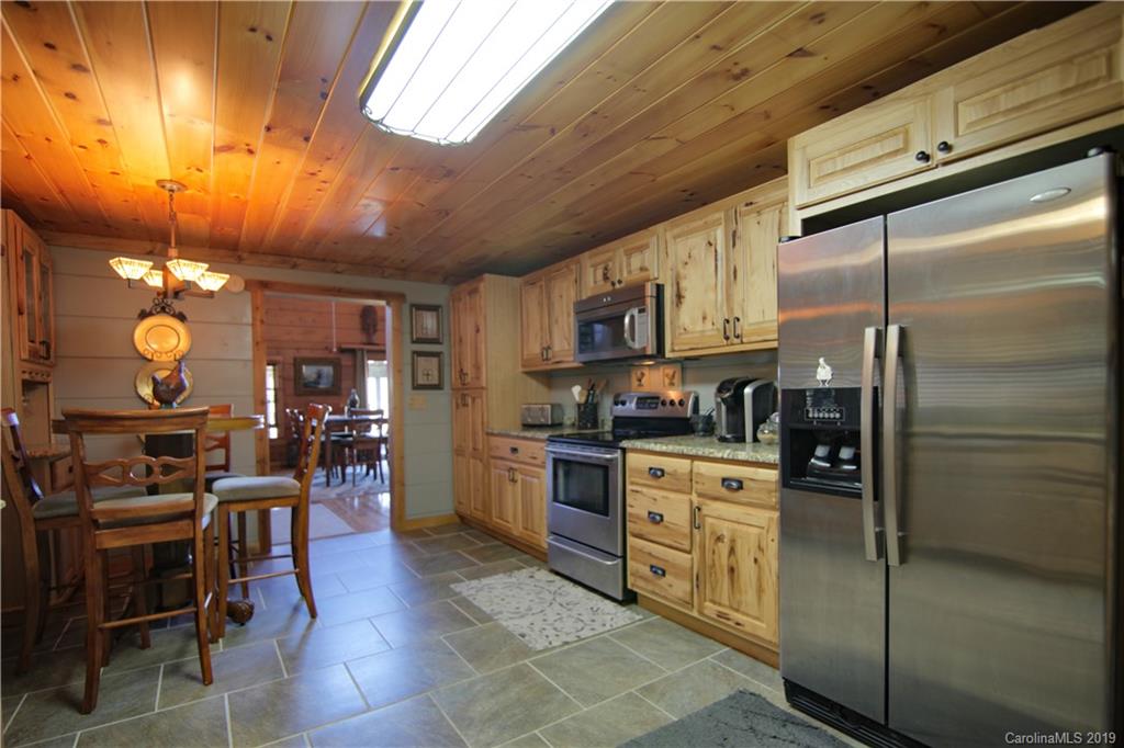 75 Stanley Dr Mill Spring Mill Spring, NC 28756 - Photo 13 of 48 a kitchen with stainless steel appliances granite countertop a refrigerator and stove