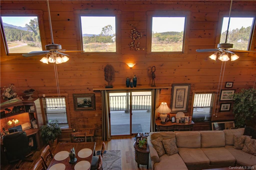 75 Stanley Dr Mill Spring Mill Spring, NC 28756 - Photo 21 of 48 a living room with furniture a chandelier and a large window