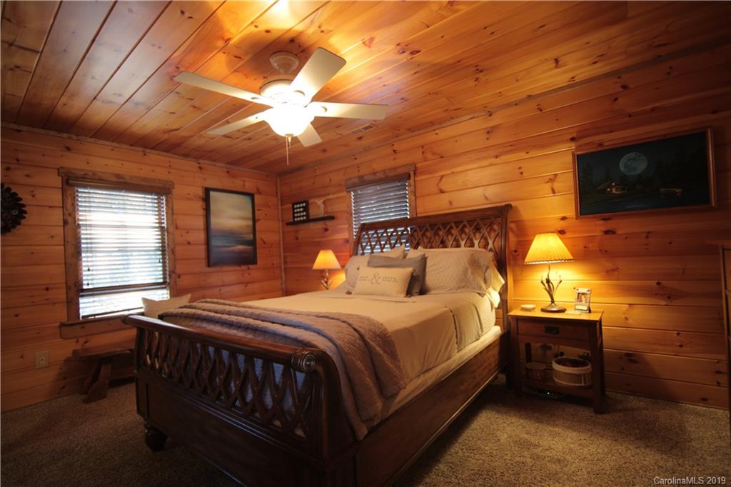 75 Stanley Dr Mill Spring Mill Spring, NC 28756 - Photo 25 of 48 a bedroom with a bed a flat screen tv and closet