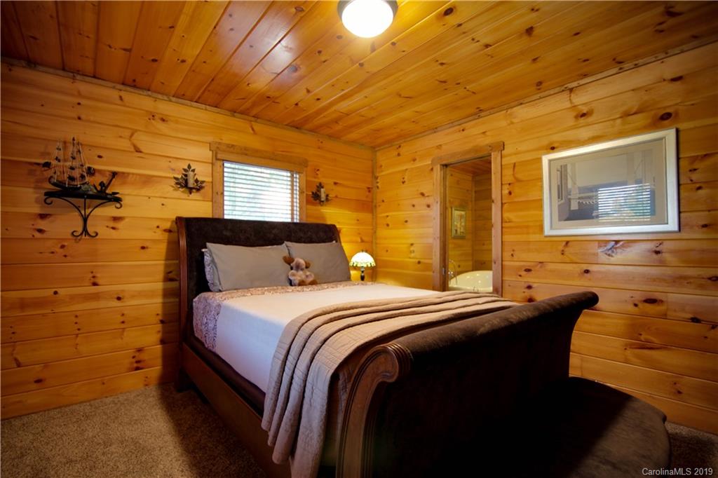 75 Stanley Dr Mill Spring Mill Spring, NC 28756 - Photo 30 of 48 a bedroom with a bed and wooden floor
