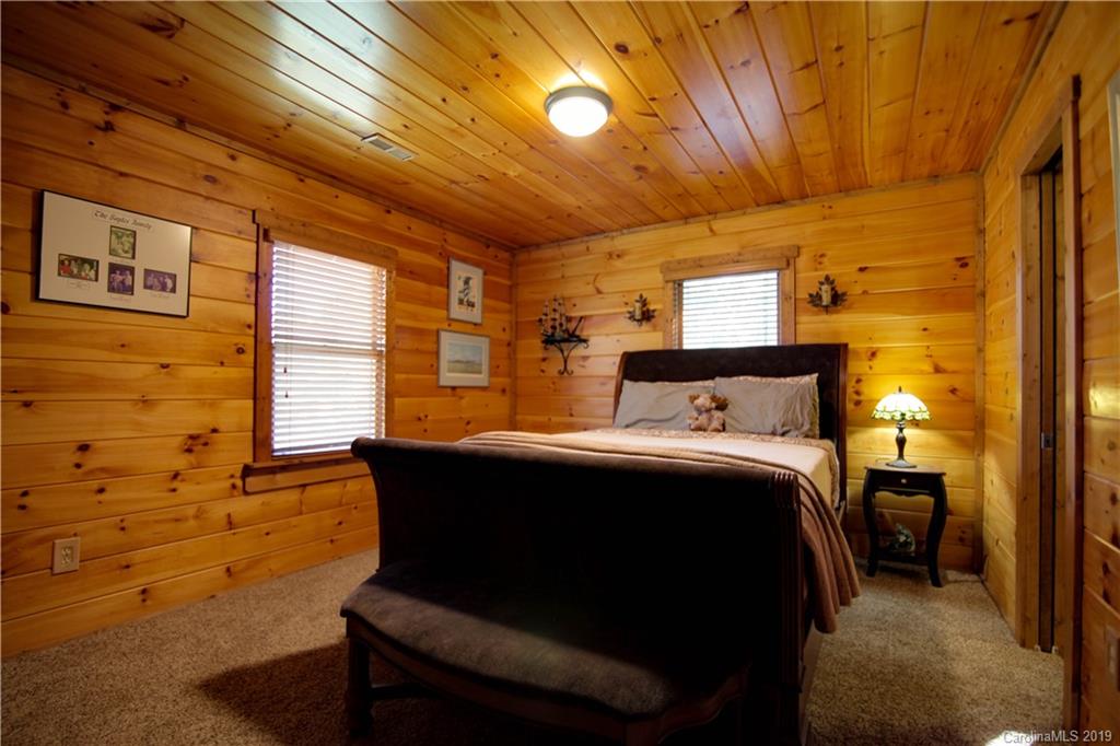 75 Stanley Dr Mill Spring Mill Spring, NC 28756 - Photo 32 of 48 a bedroom with a bed and wooden floor