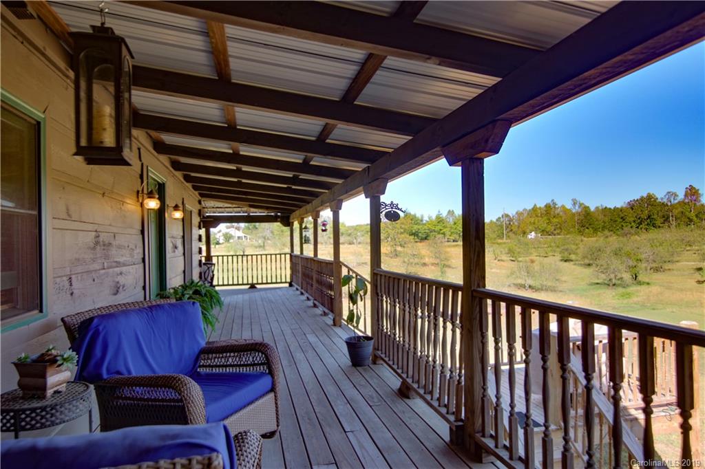 75 Stanley Dr Mill Spring Mill Spring, NC 28756 - Photo 34 of 48 a view of a porch with furniture and wooden floor
