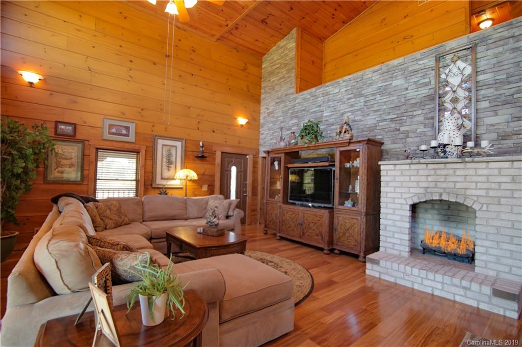 75 Stanley Dr Mill Spring Mill Spring, NC 28756 - Photo 5 of 48 a living room with furniture and a fireplace