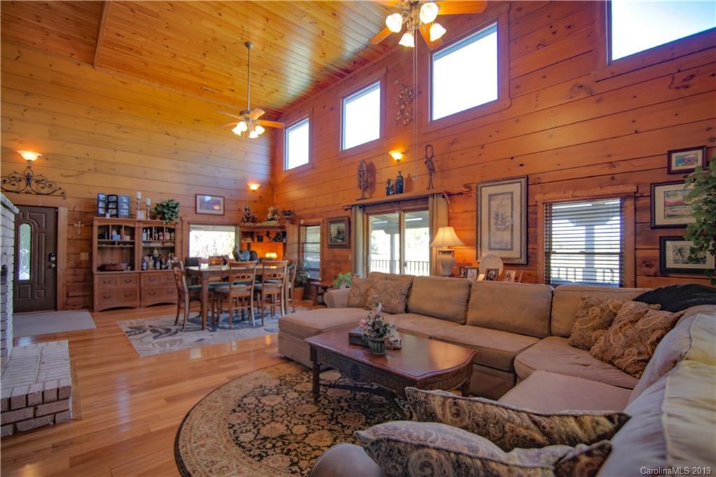 75 Stanley Dr Mill Spring Mill Spring, NC 28756 - Photo 6 of 48 a living room with furniture a large window and a clock