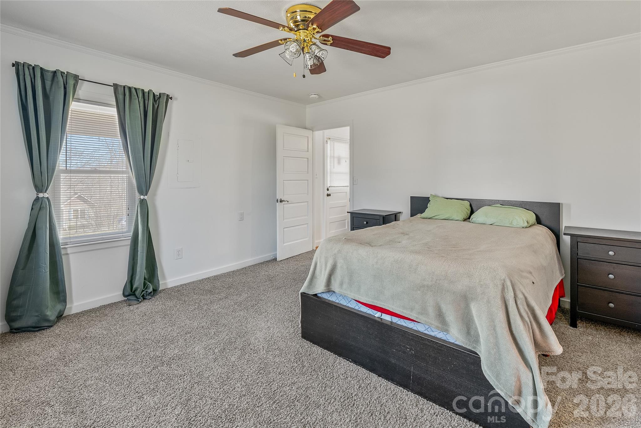 21 Ben Owenby Road Fairview, NC 28730 - Photo 18 of 38 a bedroom with a bed and a chandelier