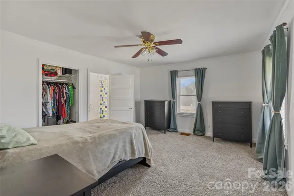 a bed room with a bed and a book shelf