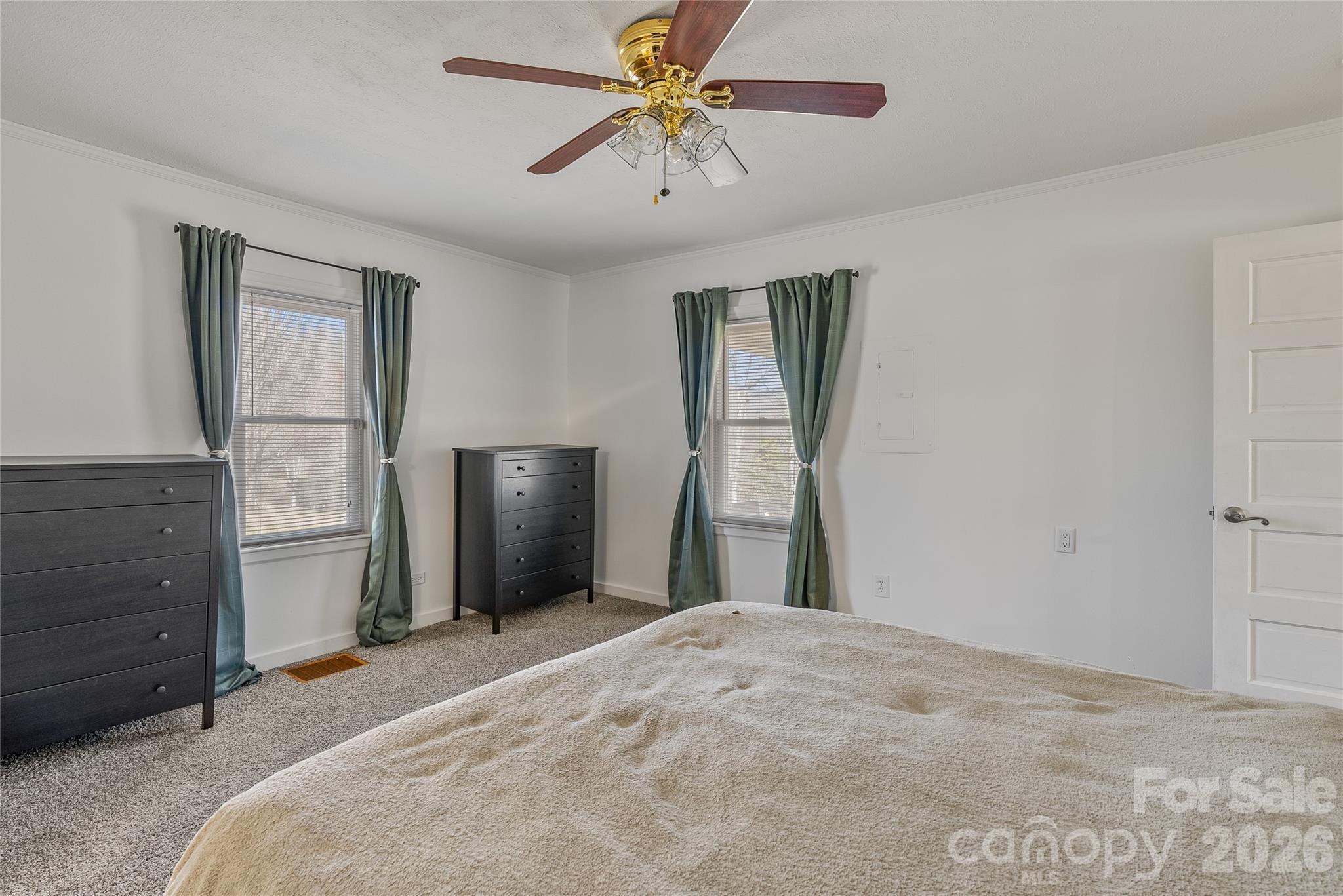 21 Ben Owenby Road Fairview, NC 28730 - Photo 19 of 38 a bedroom with a bed and a chandelier