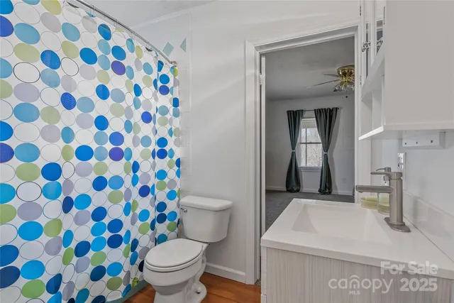 a bathroom with a sink and mirror with toilet
