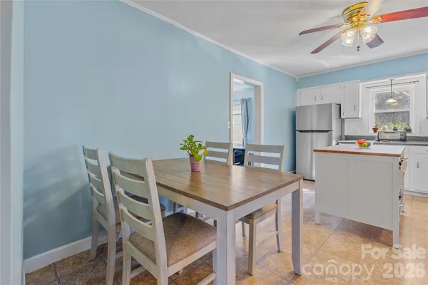 a view of a dining room that has a table and chairs in it