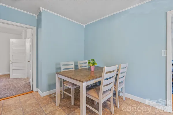 a view of a dining room that has a table and chairs in it