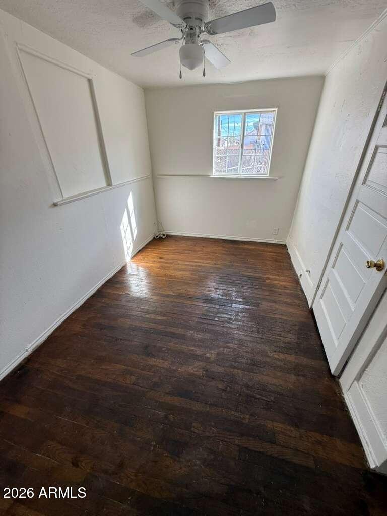 1315 C Avenue Douglas, AZ 85607 - Photo 6 of 10 an empty room with wooden floor and windows