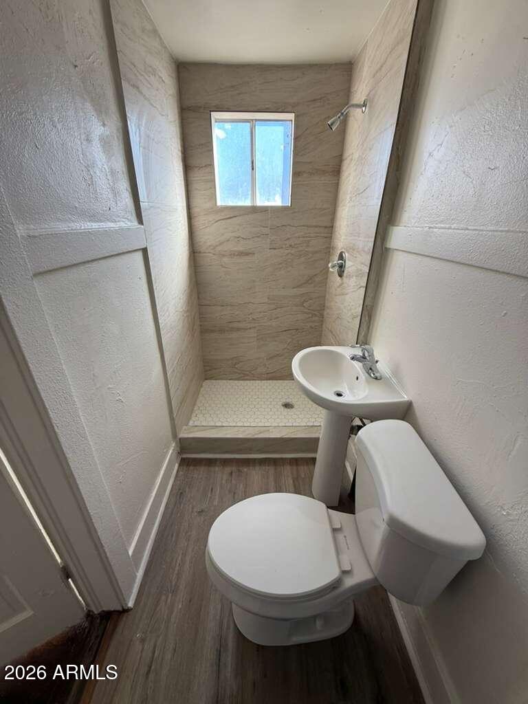 1315 C Avenue Douglas, AZ 85607 - Photo 7 of 10 a bathroom with a toilet a sink and a mirror