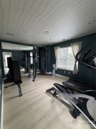 a room with gym equipment and a large window