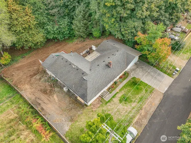 an aerial view of a house with a yard and lake view