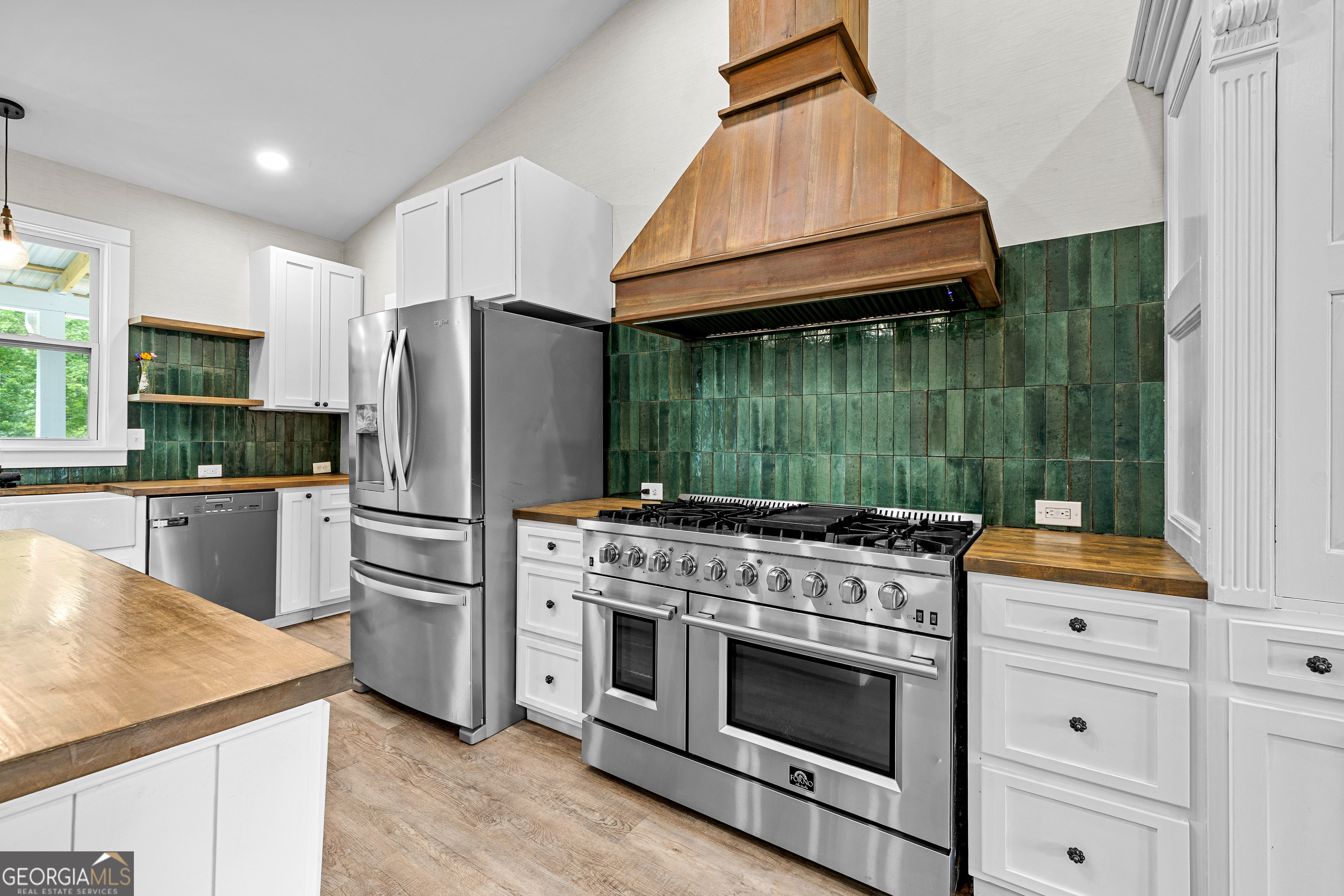 1329 Standing Rock Road Senoia, GA 30276 - Photo 11 of 77 a kitchen with a stove a refrigerator and a sink