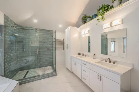 a spacious bathroom with a tub a window and a shower