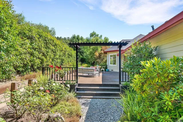 a view of a house with backyard porch and sitting area