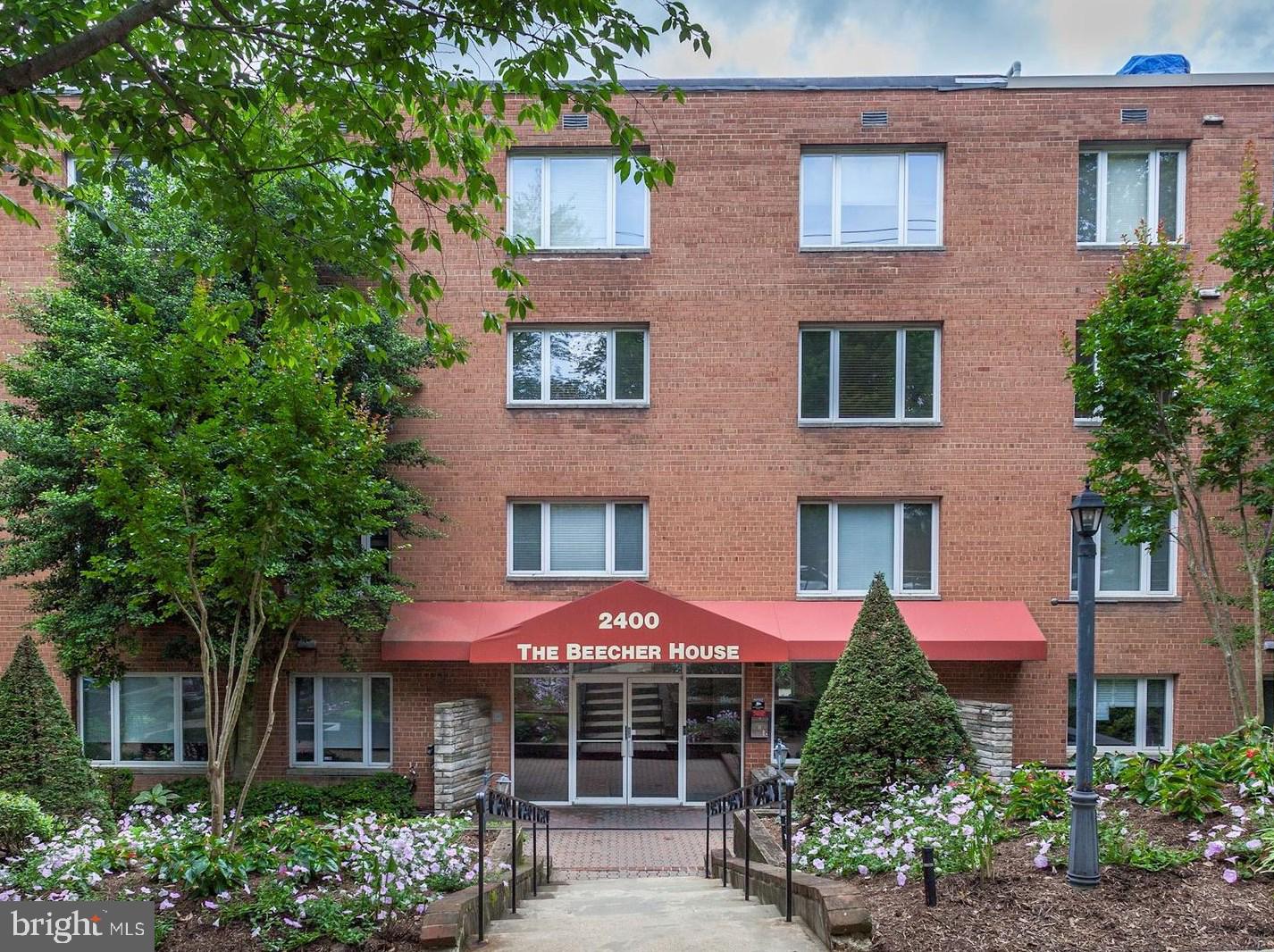 2400 41st Street Northwest, Unit 203 Washington, DC 20007 - Photo 1 of 24 a front view of a house with yard and outdoor seating