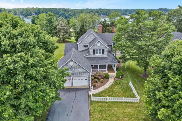 an aerial view of a house with a yard