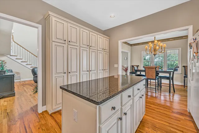 a living room with stainless steel appliances granite countertop furniture and a kitchen view