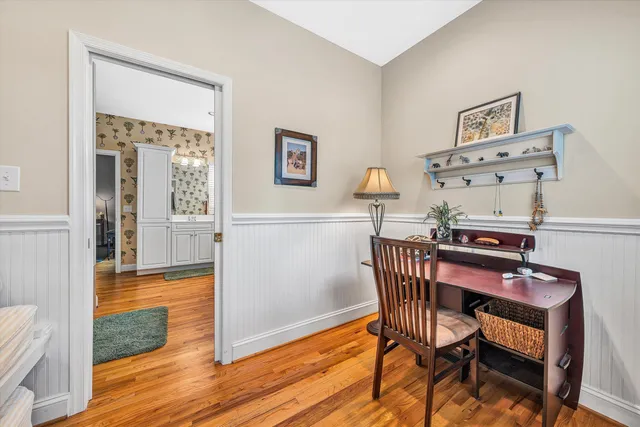 a dining room with furniture and wooden floor
