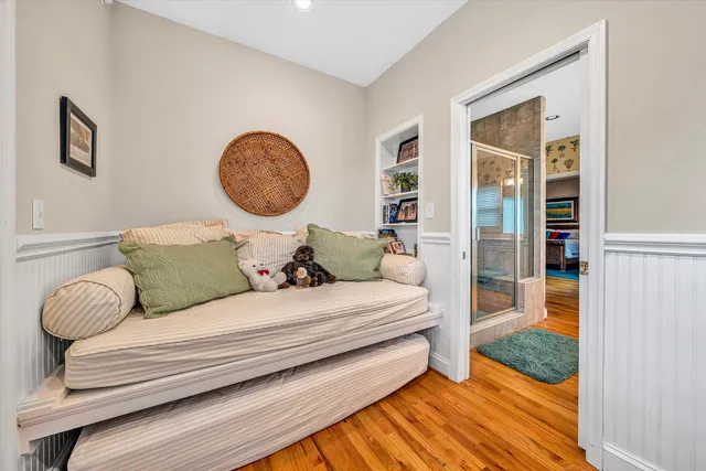 a bed sitting in a bedroom next to a window