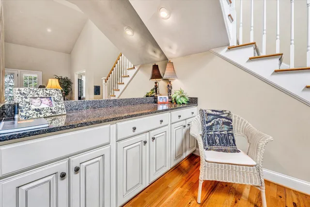 a view of staircase with railing and a rug