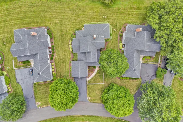 an aerial view of a house with a yard and lake view