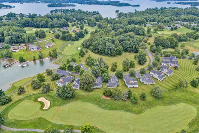 an aerial view of a house with a garden and trees
