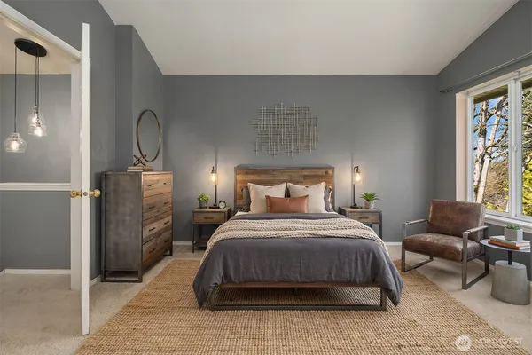 a bed sitting in a bedroom next to a window