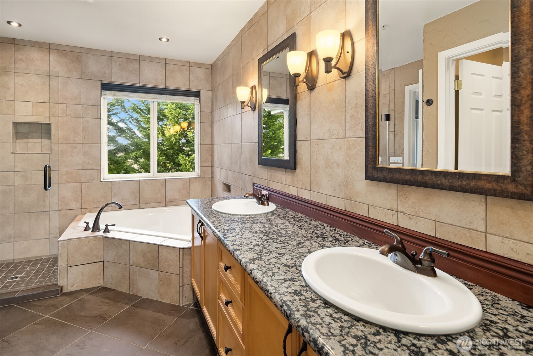 12113 Northeast 172nd Place, Unit J202 Bothell, WA 98011 - Photo 17 of 29 a bathroom with a tub sink and mirror