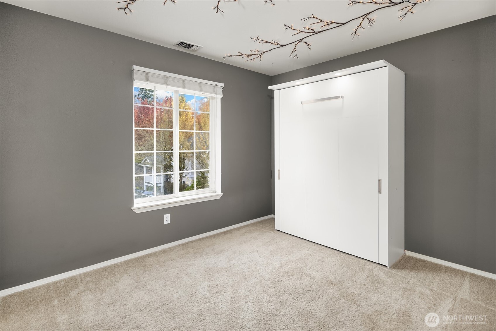 12113 Northeast 172nd Place, Unit J202 Bothell, WA 98011 - Photo 19 of 29 a view of an empty room with a window