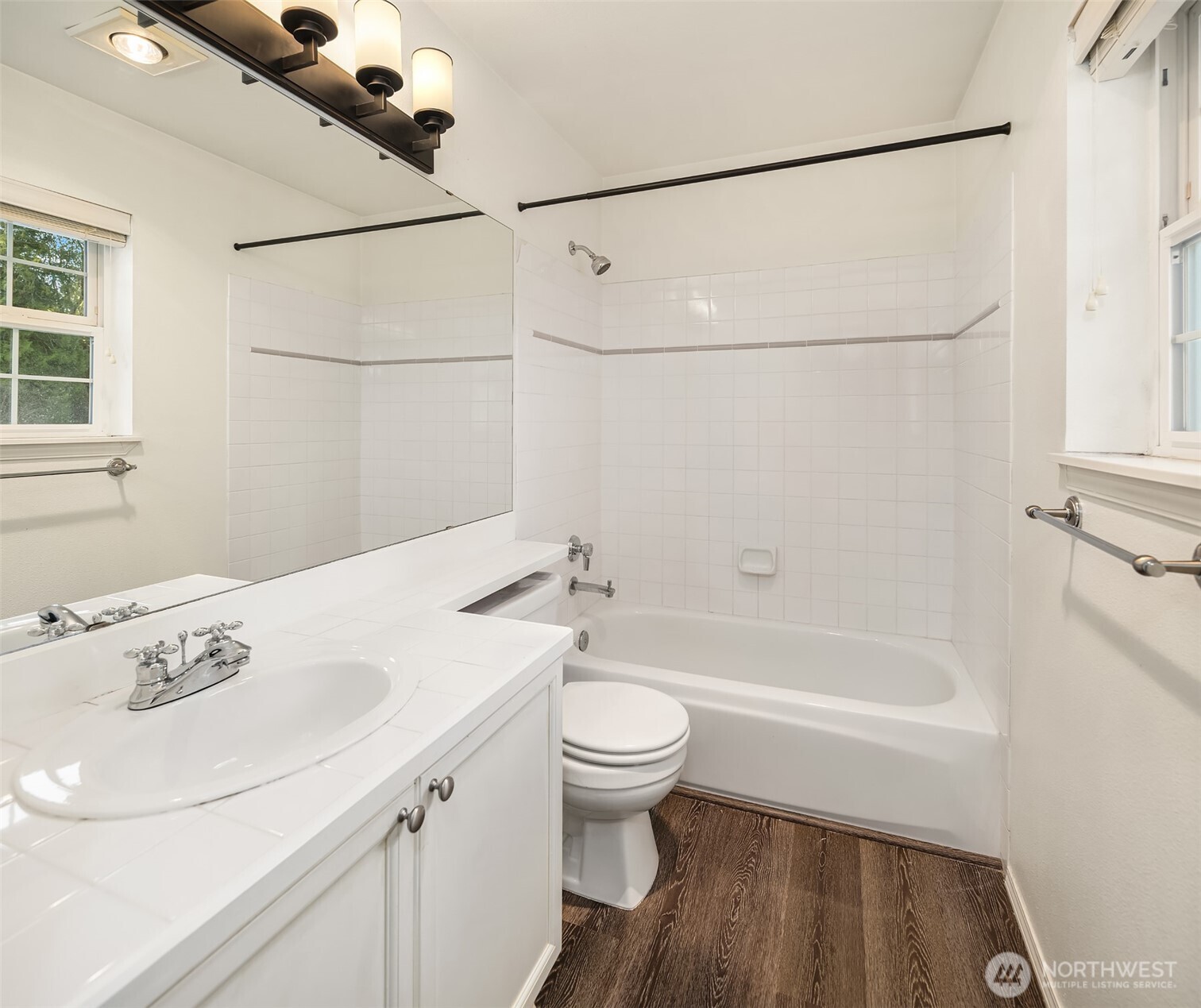 12113 Northeast 172nd Place, Unit J202 Bothell, WA 98011 - Photo 22 of 29 a bathroom with a sink a toilet and a shower