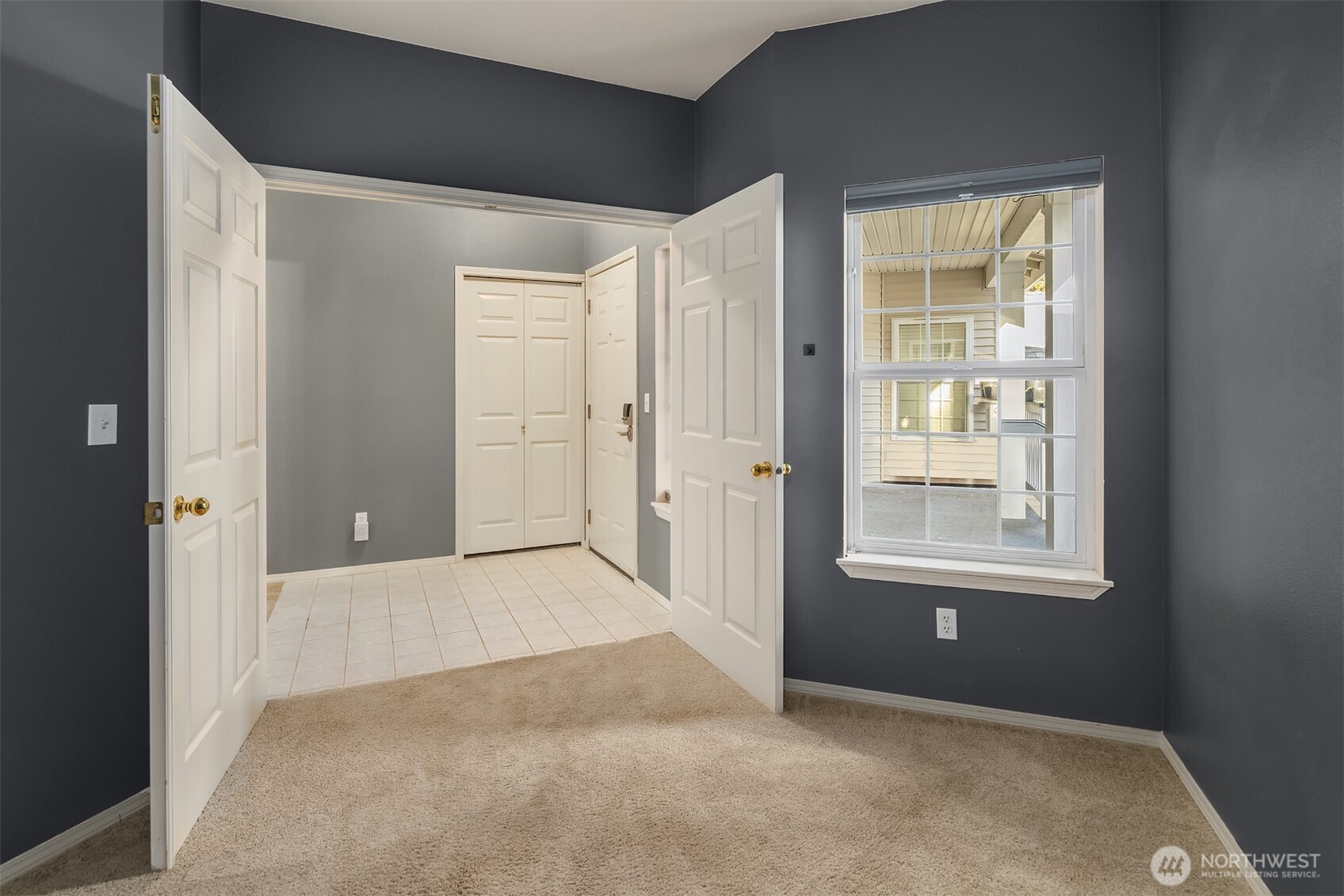 12113 Northeast 172nd Place, Unit J202 Bothell, WA 98011 - Photo 24 of 29 an empty room with windows and closet