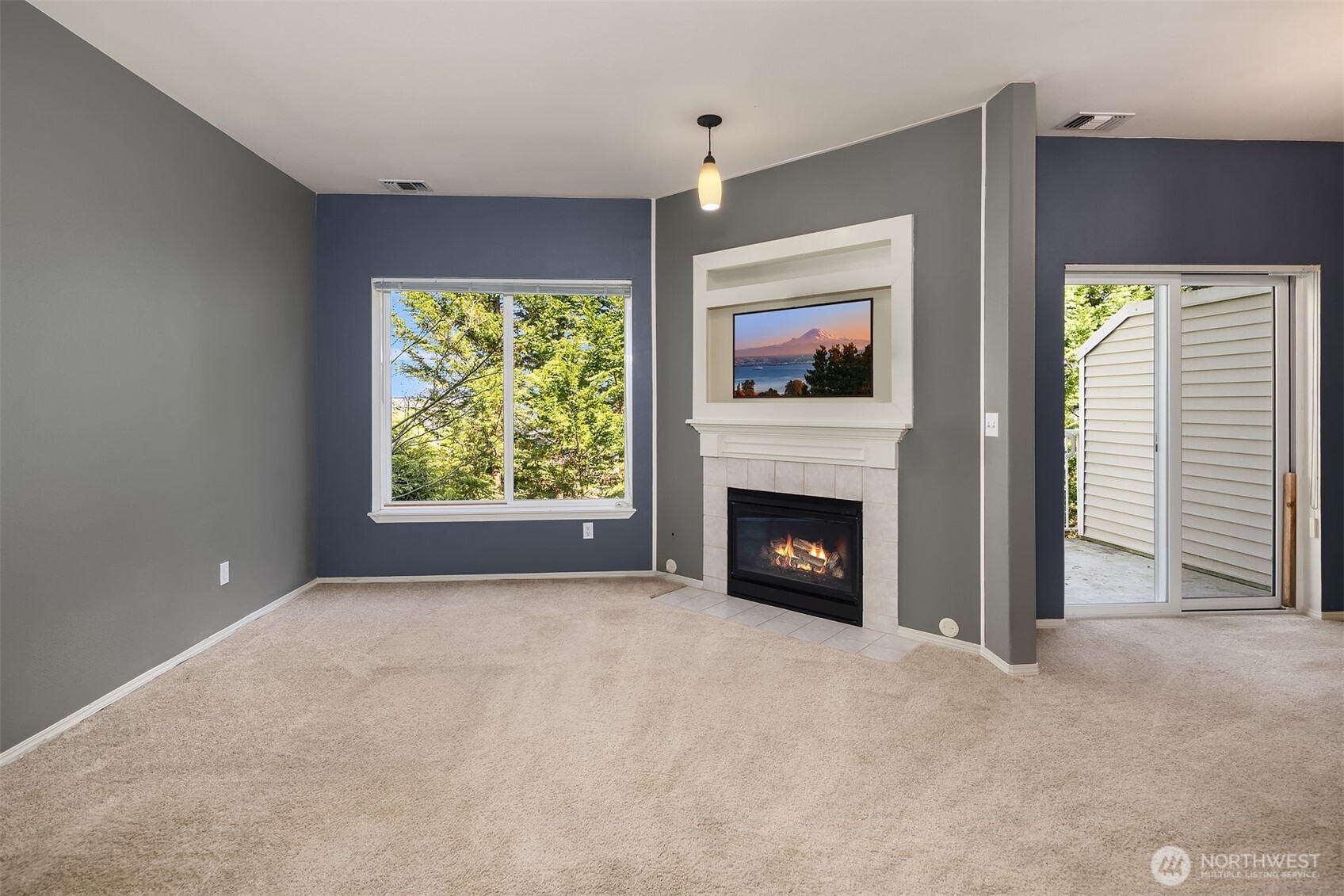 12113 Northeast 172nd Place, Unit J202 Bothell, WA 98011 - Photo 4 of 29 a view of empty room with a fireplace and large window