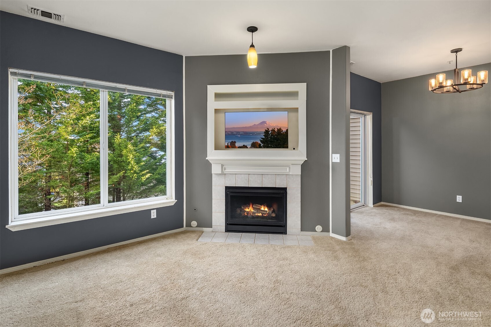 12113 Northeast 172nd Place, Unit J202 Bothell, WA 98011 - Photo 5 of 29 a living room with furniture and a fireplace