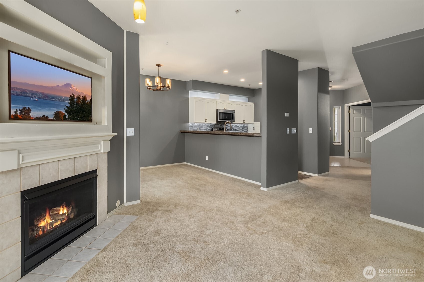 12113 Northeast 172nd Place, Unit J202 Bothell, WA 98011 - Photo 6 of 29 a view of a livingroom with a fireplace and cabinet