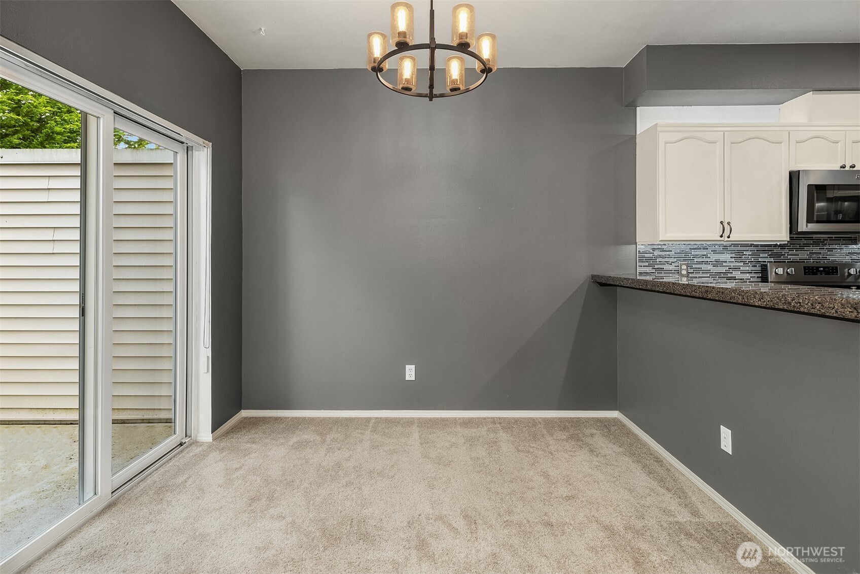 12113 Northeast 172nd Place, Unit J202 Bothell, WA 98011 - Photo 7 of 29 a view of a kitchen with a sink and a window