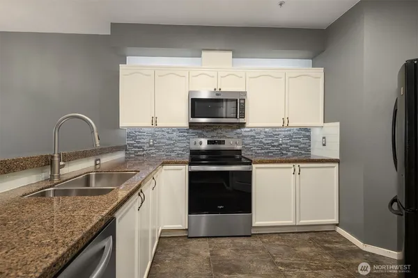 a kitchen with a sink stove and window
