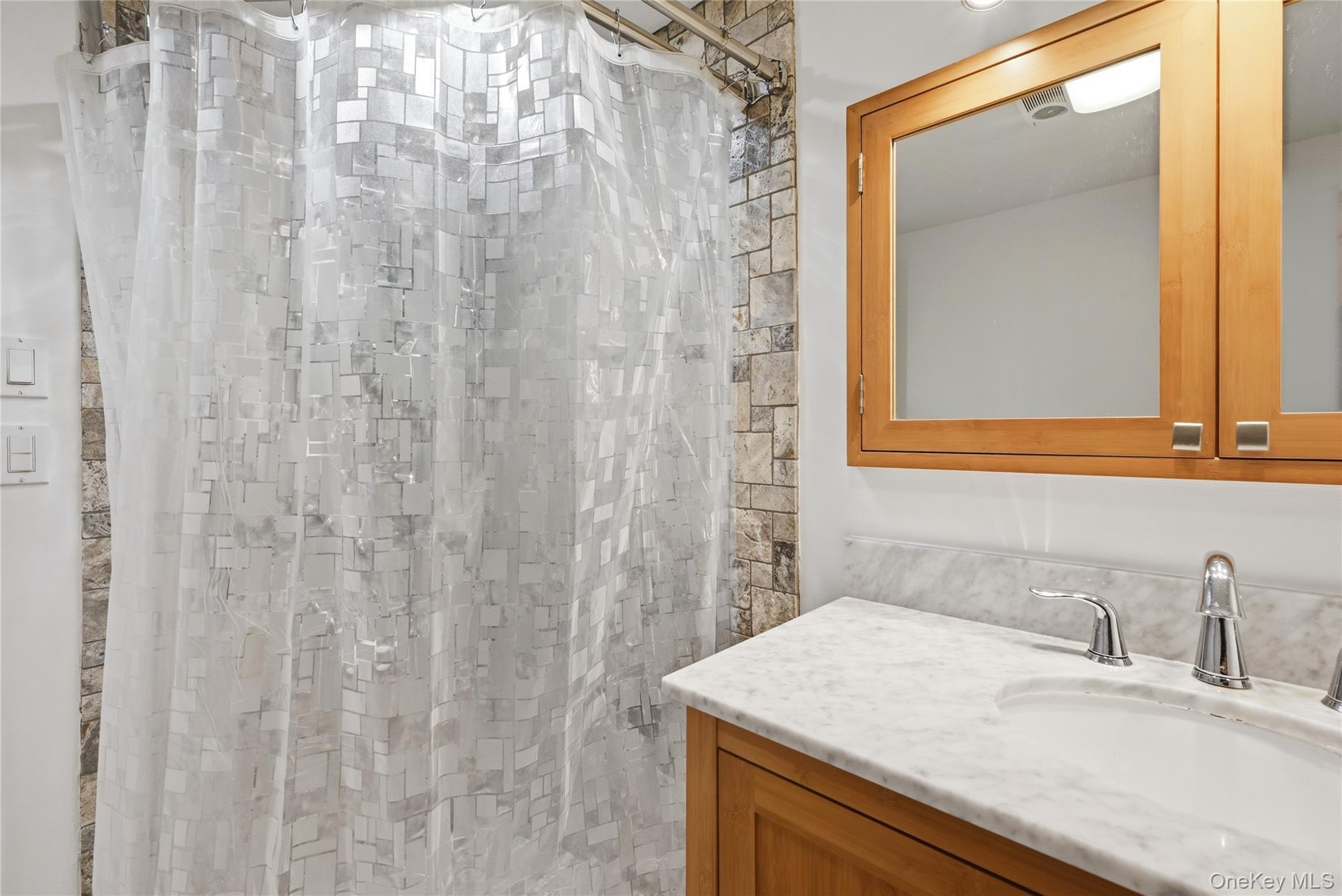 35 Randall Road Shoreham, NY 11786 - Photo 21 of 32 a bathroom with a sink and a mirror