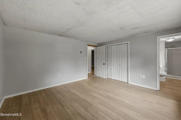 a view of an empty room and wooden floor