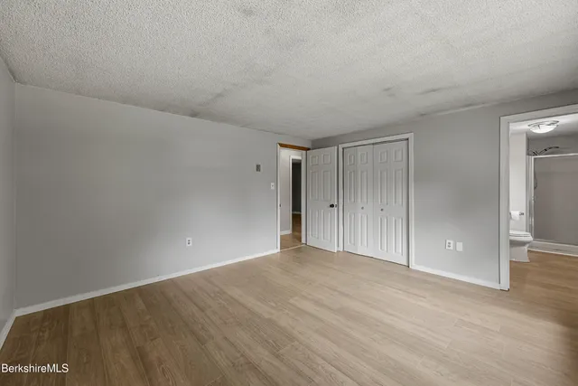 a view of an empty room and wooden floor