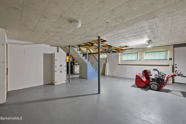 a garage with white cabinets and window