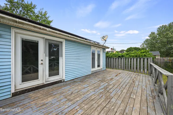 a view of deck with wooden floor and fence