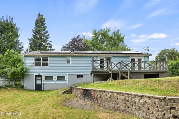a view of a house with a yard and furniture