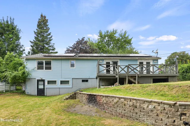 a view of a house with a yard and furniture