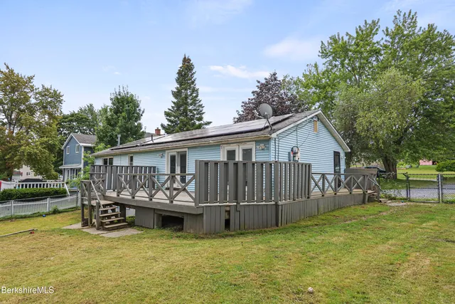 a view of a house with pool and a yard