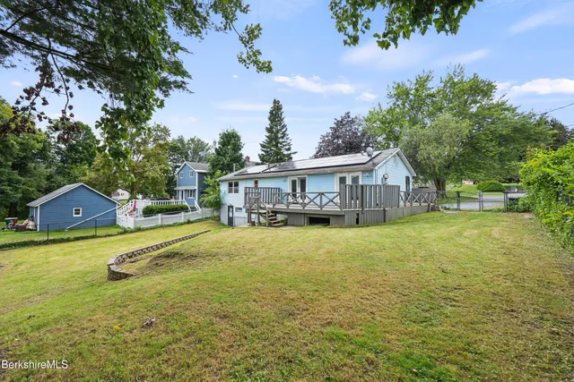 a house view with swimming pool in front of it