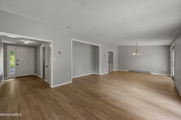a view of a livingroom with wooden floor and a window